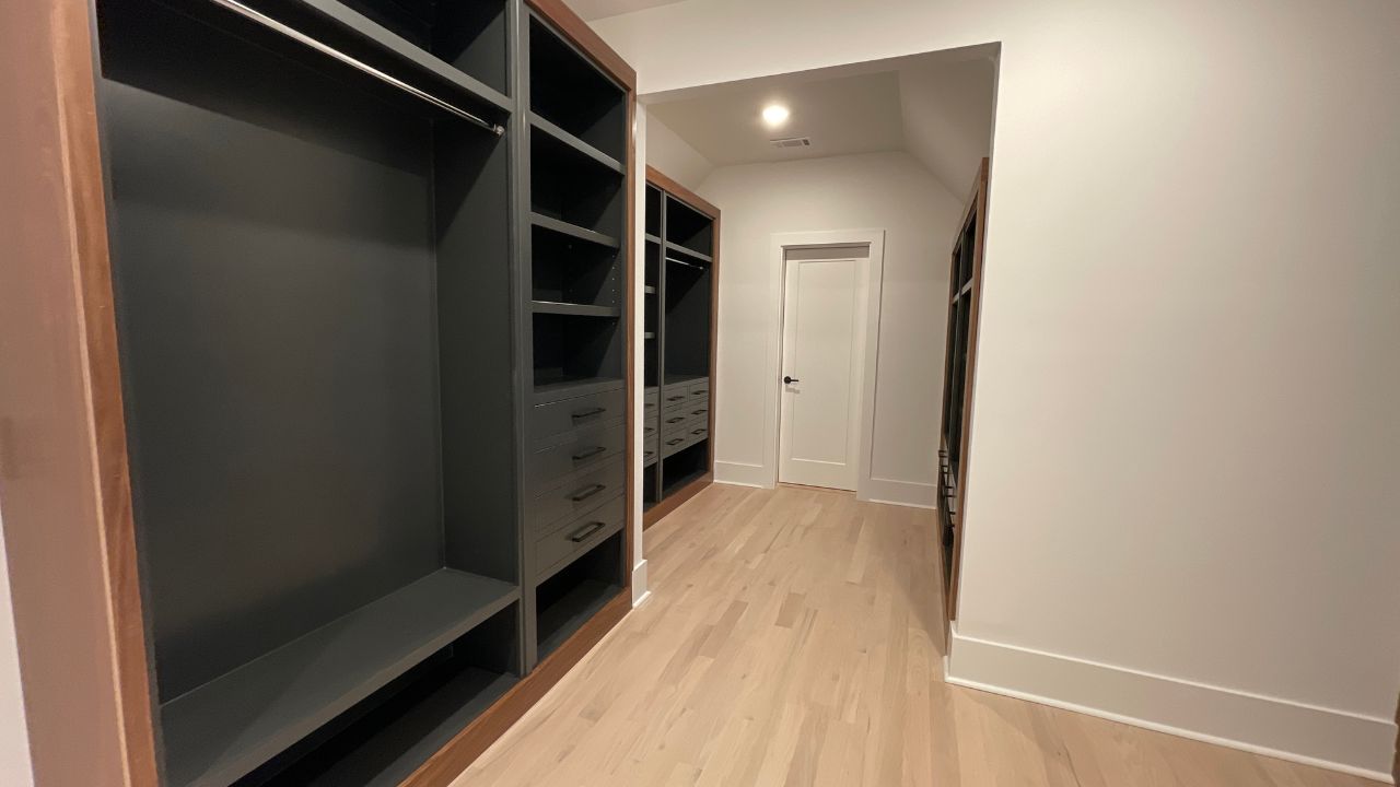 Primary walk-in closet by Six Points Homes