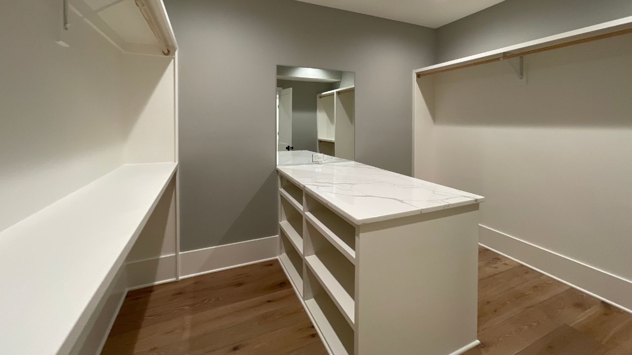 Primary walk-in closet by Classic Cottages