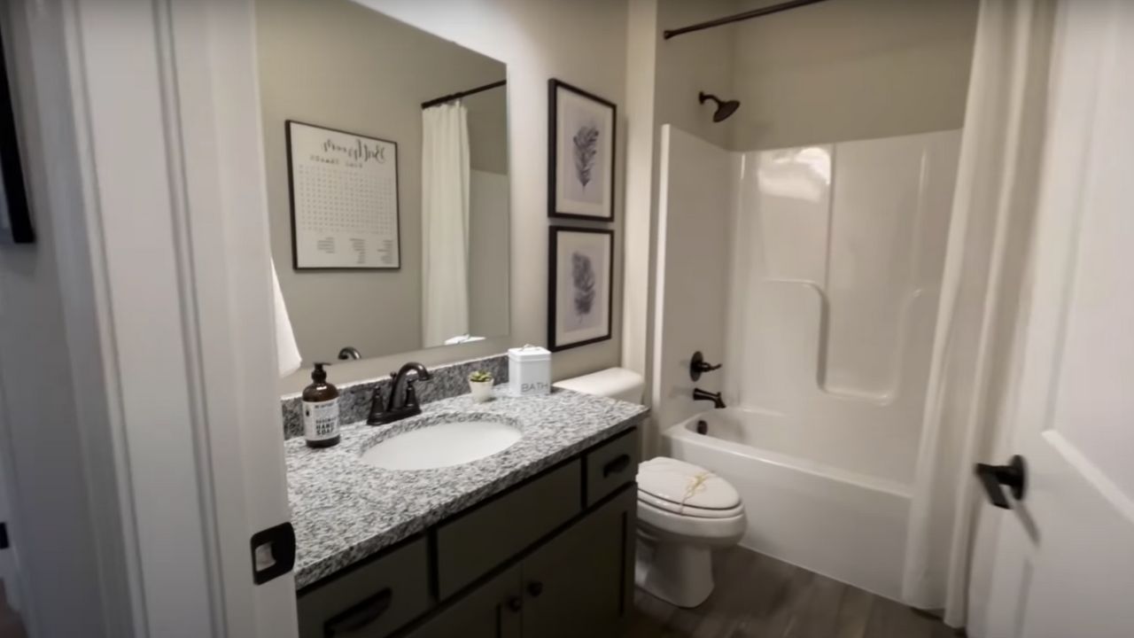 Full bathroom with granite countertops 